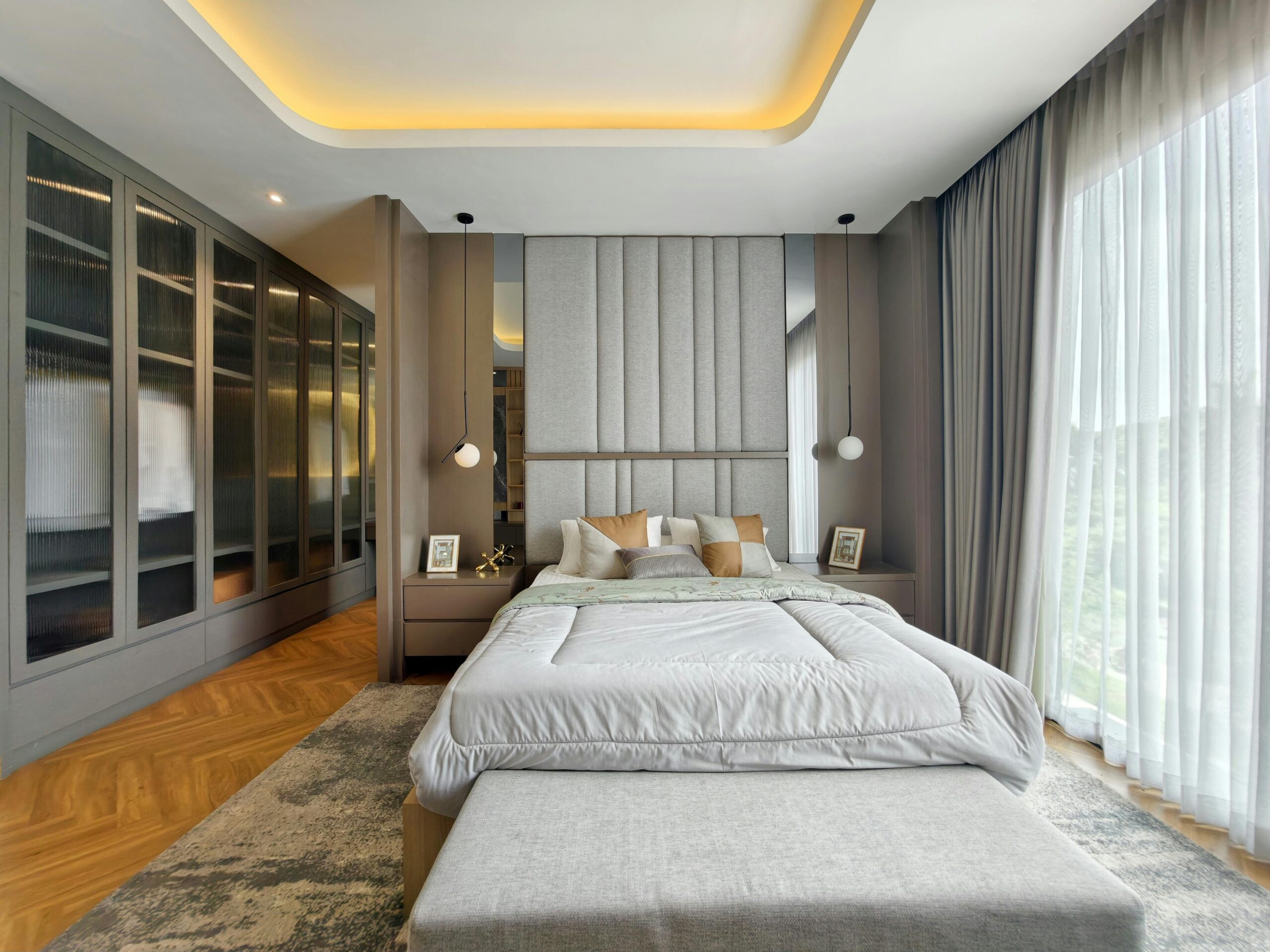 Luxurious modern bedroom design featuring large windows and sophisticated decor.